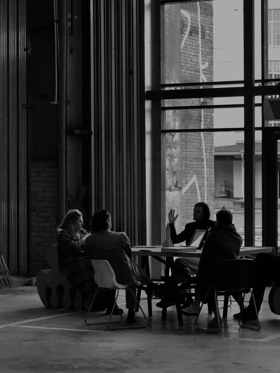 A leadership team meeting in a glass-walled boardroom